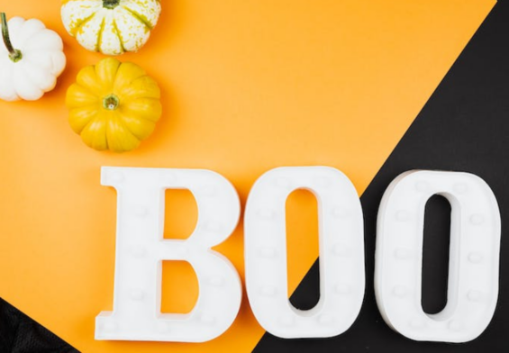 scritta boo su sfondo arancione e nero con zucche